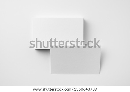 Design concept - top view of 2 horizontal business card isolated on white background for mockup, it's real photo, not 3D render