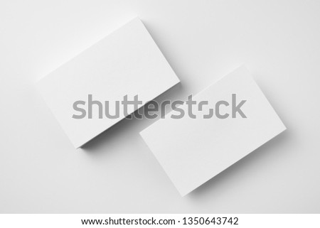 Design concept - top view of 2 horizontal business card isolated on white background for mockup, it's real photo, not 3D render