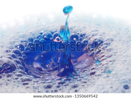 foam on the surface of the liquid and the trace of a drop of water
