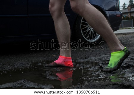 Colorful socks walking through mud.