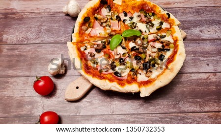 Close up of  italian  style salami pizza. Ham, bacon, yellow cheese, olives, tomato sauce , mushrooms and chilly peppers.