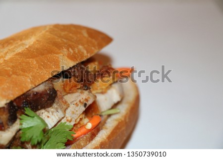 Bahn Mi is a Vietnamese cuisine. A sandwich consisting of a baguette filled with meat, pork, coriander leaf, cucumber, pickled carrots, cabbage, and deacon