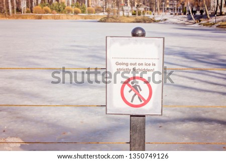 danger warning sign near the lake , do not go out on thin ice, lake or river in city park