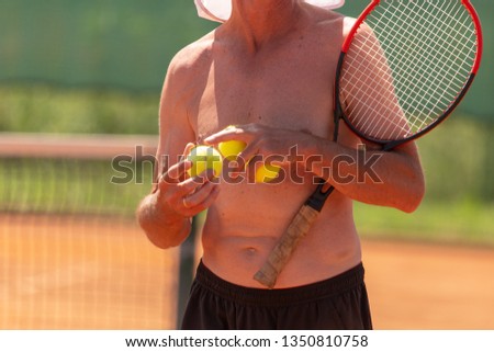 A man plays tennis on the court in the park .