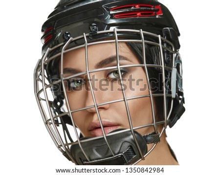 Female hockey player close up helmet and mask over white studio background