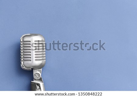 Retro microphone on grey background
