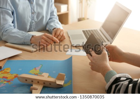 Client discussing tour with travel agent in office