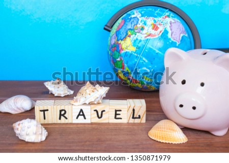 Travel and holiday concept, piggy bank, shells and globe on the blue background. 