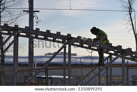 Welder working at height. Welding work on the construction. Iron construction.