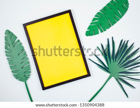 Decorative wooden tropical leaves and empty frame with copy space. Summer vacation, greeting card, space for text