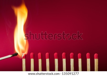 Burning match setting fire to its neighbors, a metaphor for ideas and inspiration Royalty-Free Stock Photo #135091277