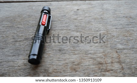 Brush for brushing the camera lens on a wooden table