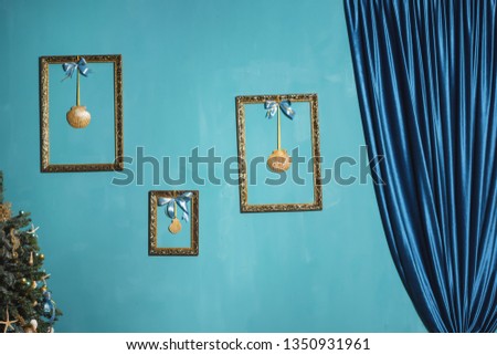 Decoration of the room in the marine style. Gold frames on blue wall background. Decorative element. Vintage gold-plated frame with seashells. Vintage photo zone.