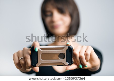 beautiful business woman taking selfie by phone isolated on gray background