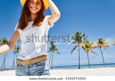 pretty woman in white t-shirt hat on the beach palm trees white sand ocean summer holiday