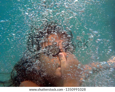 take a dive underwater holding your breath Royalty-Free Stock Photo #1350991028