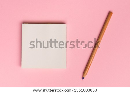 Top view flat lay picture with blank notepad page and pencil on colored surface