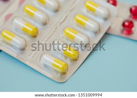 pharmaceuticals antibiotics pills medicine. Colorful antibacterials pills on blue background. Capsule pill medicine 