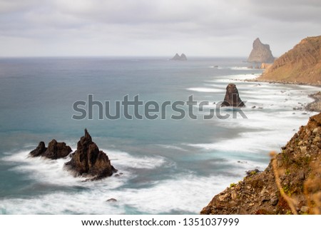 rocks and seascape seen from the cliffs with rough ocean. Tenerife island in spring