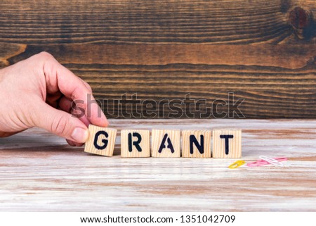  Grant. Wooden letters on the office desk, informative and communication background