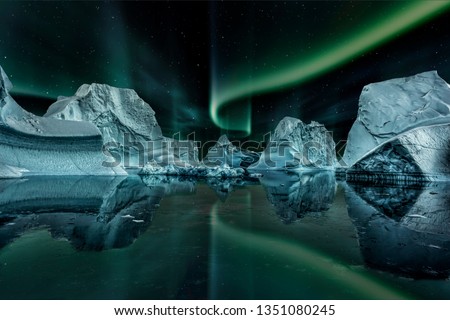 iceberg floating in greenland fjord at night with green northern lights. Royalty-Free Stock Photo #1351080245