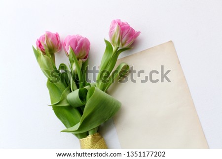Bouquet of pink tulips on white wooden background. Top view. Flat lay. Copy space. Valentines day, mothers day, birthday, wedding celebration concept.