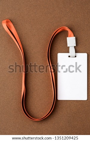Empty security tag on brown background. Place for text, layout
