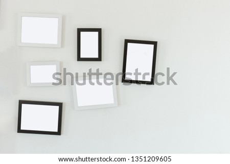 frames hanging on white wall