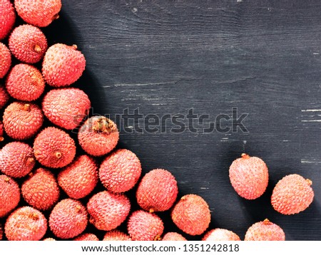 lichee fruit on dark wooden background close up with copy space. Top view or flat lay