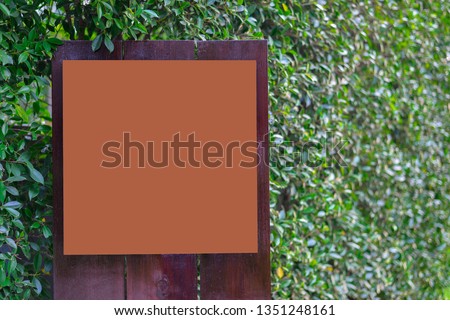 Mock up blank advertising brown colour board
with nature background for display or space for text.