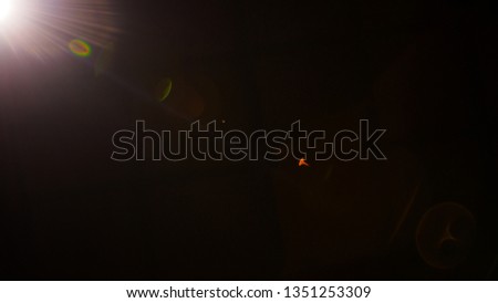 Flash of a distant abstract star. Abstract sun flare. The lens flare is subject to digital correction. - Image