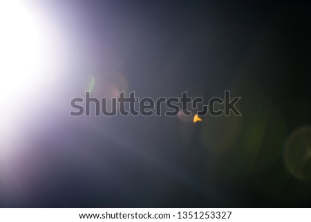 Flash of a distant abstract star. Abstract sun flare. The lens flare is subject to digital correction. - Image