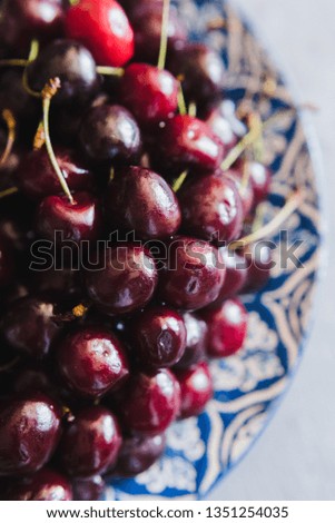 Sweet cherries on a plate with a pattern
