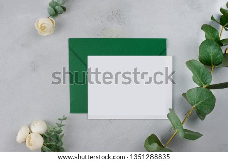 
white sheet of paper on the background of flowers