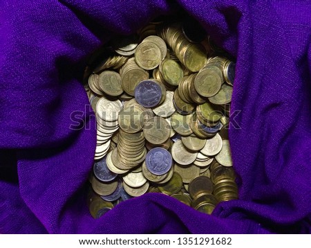 silver and gold coins on purple background