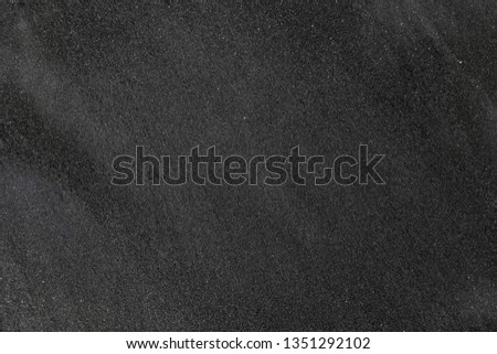 Black Sand beach macro photography. Texture of black volcanic sand for background.