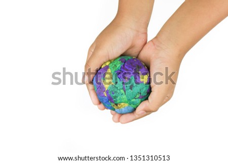 Color plasticine  is a world in the imagination of children on the hands of Asian girls, aged 8-10 years old. Handmade plasticine Earth , modelling clay with clipping path. plasticine speech bubble is