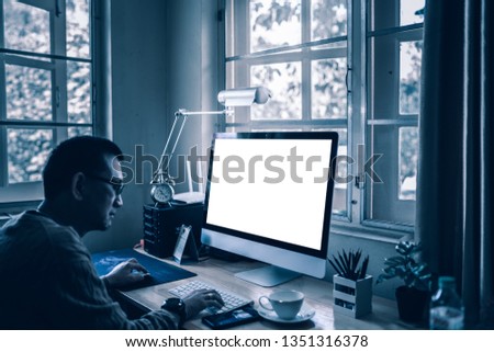 Man with mockup blank screen desktop computer at the office desk for responsive design present