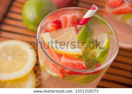 Strawberry Lemonade or mojito cocktail with lemon and mint, cold refreshing drink or beverage