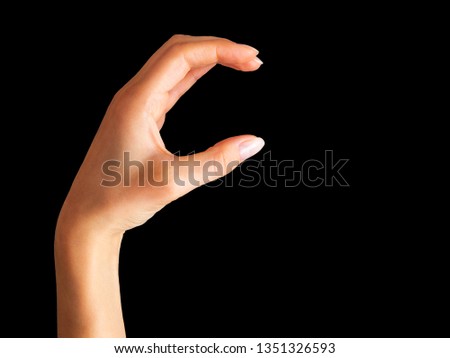 Woman hand showing picking up pose or holding something on black background. Isolated with clipping path.