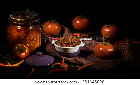 South Indian Tomato pickle in dark background. Dark food photography style.