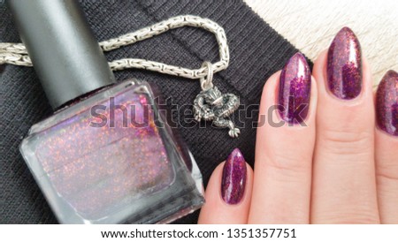 Female hands with long nails with purple nail polish