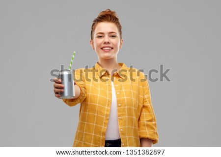 drinks and people concept - smiling teenage girl in yellow checkered shirt drinking soda from can with paper straw over grey background