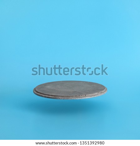 Round levitating a pedestal on a blue background. Stand for your design or text. Minimal concept. Royalty-Free Stock Photo #1351392980