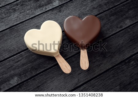 Two ice creams with heart shape on wood