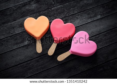 Three heart-shaped ice creams in pink colors
