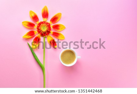 Good morning. A cup of coffee, and a card with copy space for text. A cup of coffee with flower petals. Spring or summer background with copy space for text: blank stationery template. Top view.