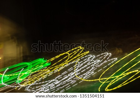 creative photography with unusual pattern of dancing light or neon in chaotic multi colored lines on abstract background. concept of unique desktop wallpaper or screensaver. copy space, texture, blur