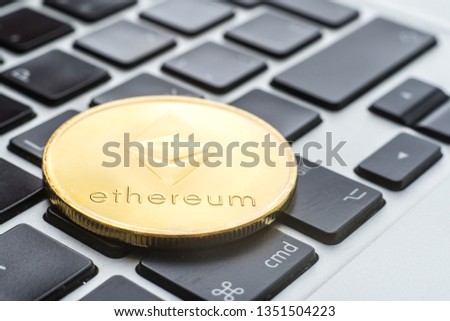 Ethereum cryptocurrency. the gold coin lies on the keyboard