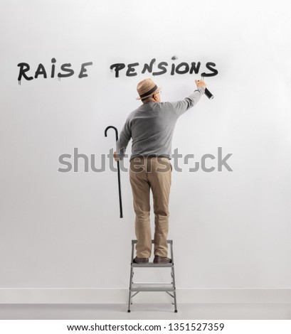 Full length shot of a senior man on a ladder writing graffiti on wall for raising pensions isolated on white background